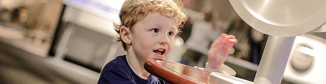 Boy plays with exhibit