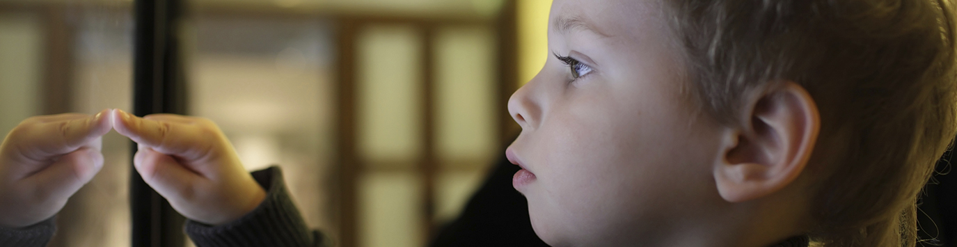 Boy using interactive touch screen